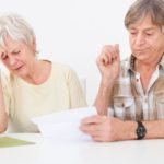 A frustrated couple does not understand the fine print of their insurance coverage.